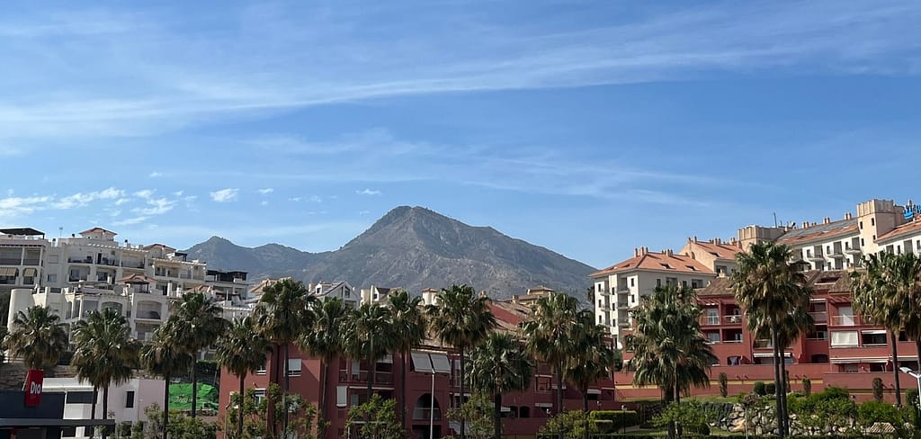 White and red apartment houses with scenic views of a mountain