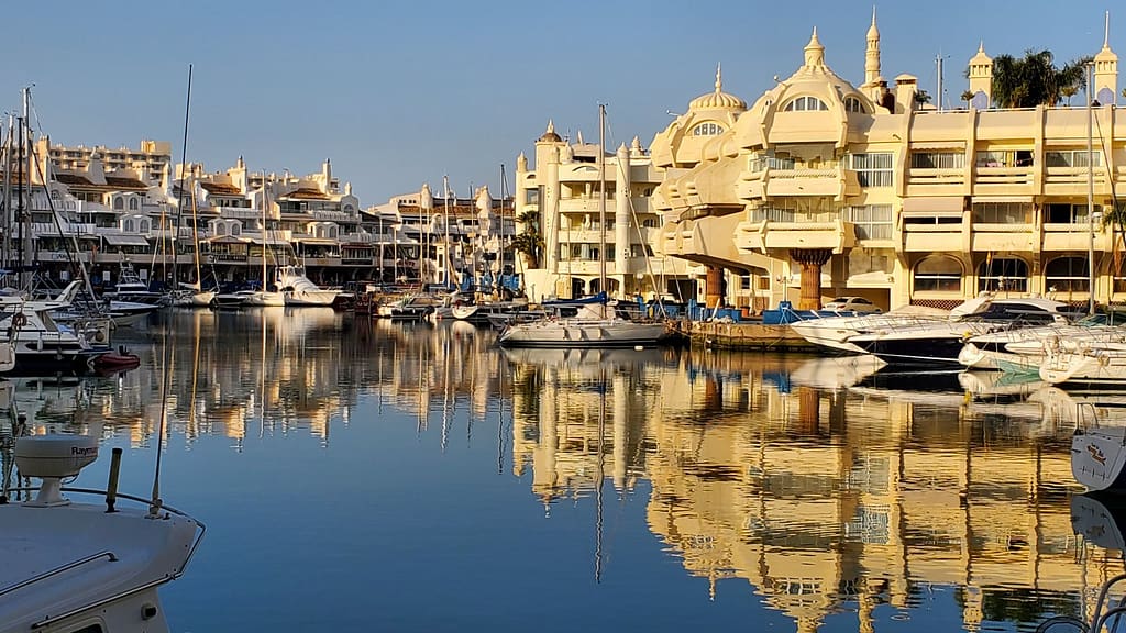Lit up by the sun, uniquely designed houses in the marina are reflected in the water creating gorgeous scenic views