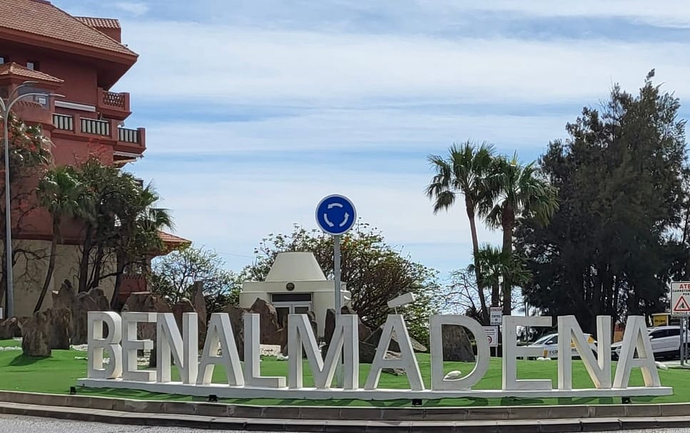 A large sign saying Benalmadena welcomes visitors at a highway exit
